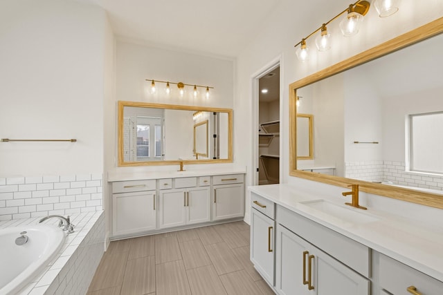 10021 Preserve Way, Conroe, TX 77385 - bathroom with two vanities, a bath, and tile patterned floors