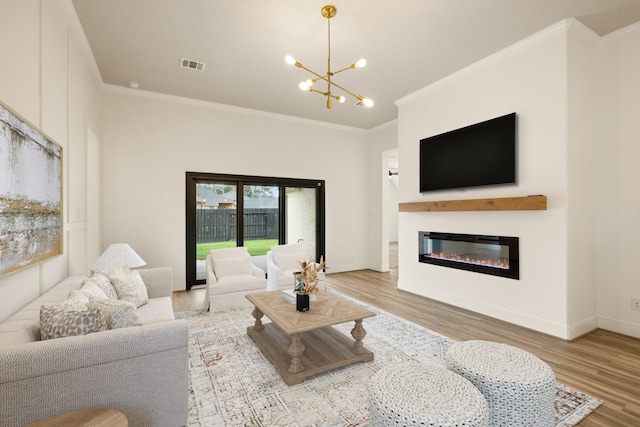 10021 Preserve Way, Conroe, TX 77385 - living room with crown molding, wood finished floors, a chandelier, a glass covered fireplace, and baseboards