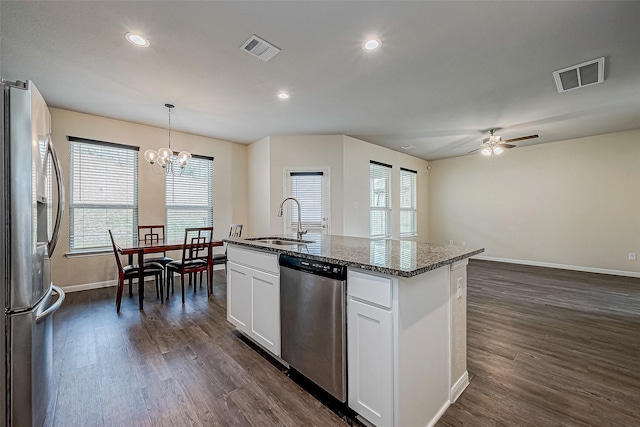 kitchen with dark wood-style flooring, visible vents, stainless steel appliances, and a sink