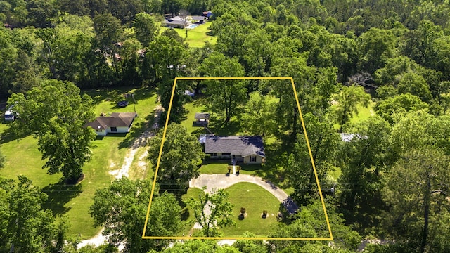 birds eye view of property featuring a wooded view