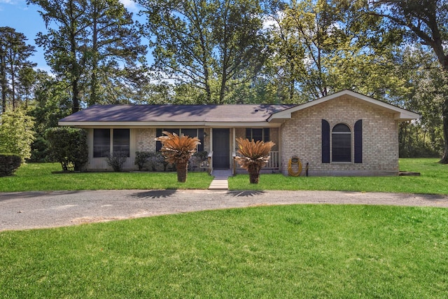 single story home featuring brick siding and a front lawn