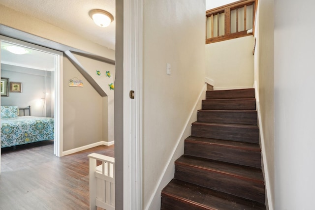 4211 San Jacinto Dr, Galveston, TX 77554 - stairway featuring baseboards and wood finished floors