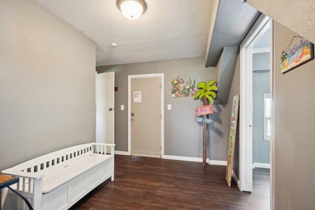 4211 San Jacinto Dr, Galveston, TX 77554 - interior space featuring baseboards, a textured ceiling, and dark wood-style flooring