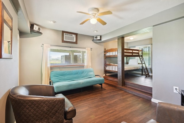 4211 San Jacinto Dr, Galveston, TX 77554 - bedroom featuring a wall mounted air conditioner, baseboards, and wood finished floors