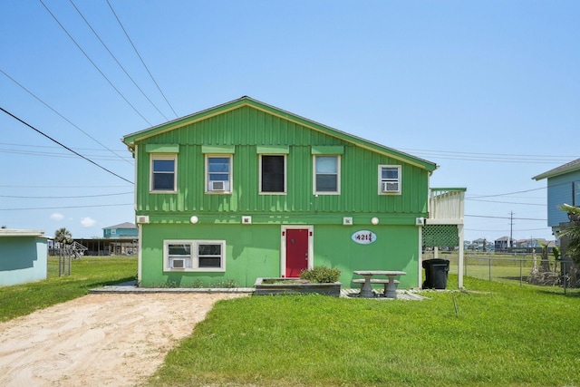 4211 San Jacinto Dr, Galveston, TX 77554 - back of property featuring a lawn, fence, and driveway