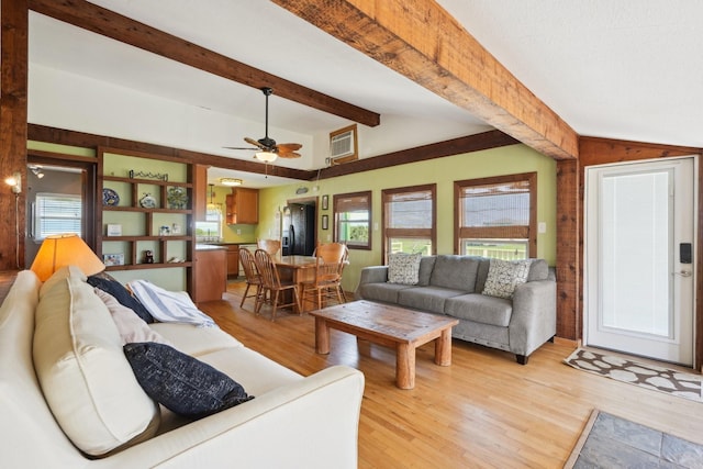 4211 San Jacinto Dr, Galveston, TX 77554 - living area featuring lofted ceiling with beams, a ceiling fan, light wood-style floors, and visible vents