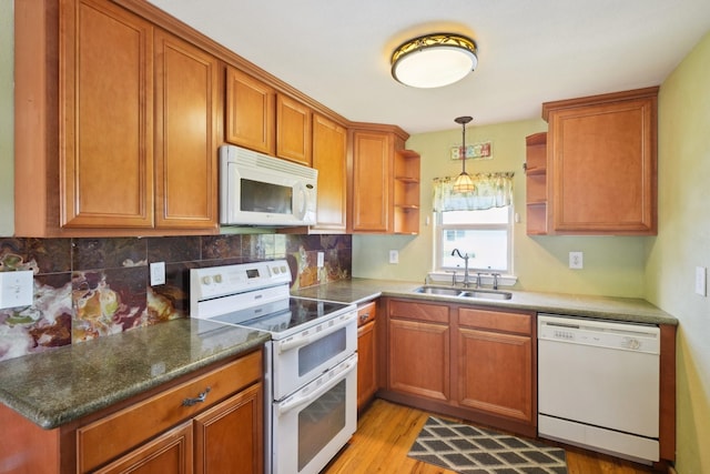 4211 San Jacinto Dr, Galveston, TX 77554 - kitchen featuring brown cabinets, open shelves, backsplash, a sink, and white appliances