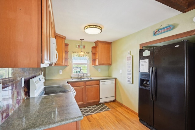 4211 San Jacinto Dr, Galveston, TX 77554 - kitchen with light wood finished floors, a sink, white appliances, brown cabinets, and open shelves