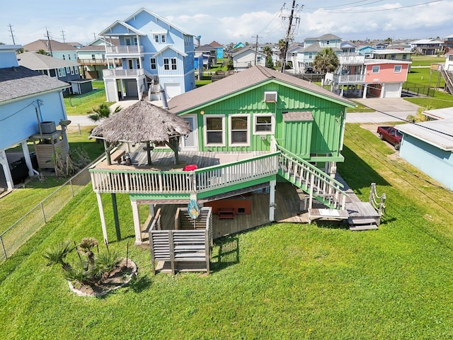 4211 San Jacinto Dr, Galveston, TX 77554 - back of property with a yard, a wooden deck, stairway, and a residential view