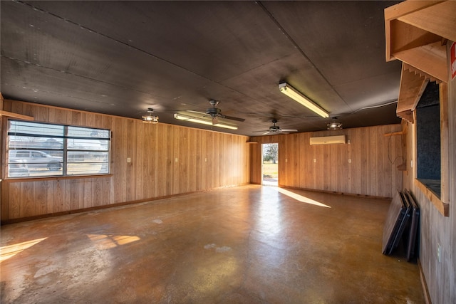 5606 S US Highway 77, Warda, TX 78960 - garage featuring a wall mounted AC, wood walls, and a ceiling fan