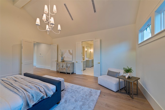 bedroom featuring a chandelier, light wood-type flooring, baseboards, and high vaulted ceiling