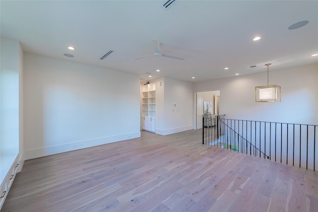 spare room featuring baseboards, light wood-style floors, and recessed lighting