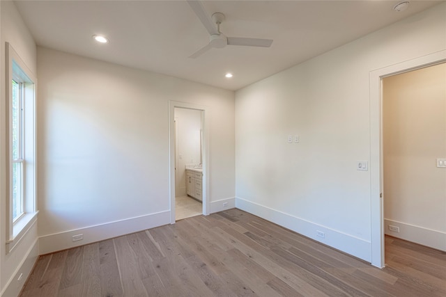 unfurnished room with light wood finished floors, a ceiling fan, baseboards, and recessed lighting