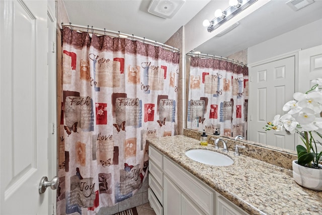 bathroom featuring a shower with shower curtain, visible vents, tile patterned flooring, and vanity