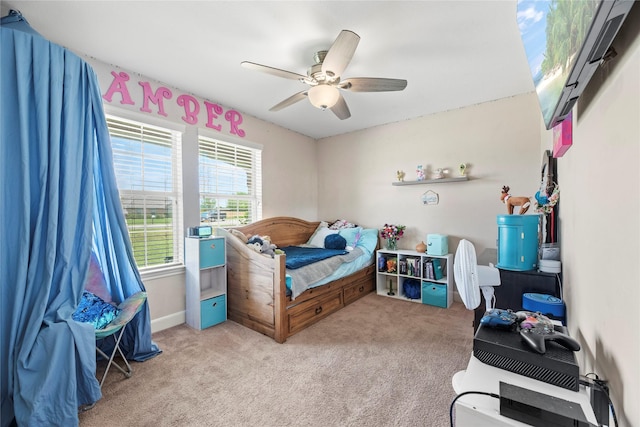 bedroom with a ceiling fan and light colored carpet