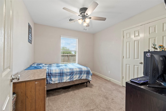bedroom with visible vents, a ceiling fan, baseboards, and light carpet