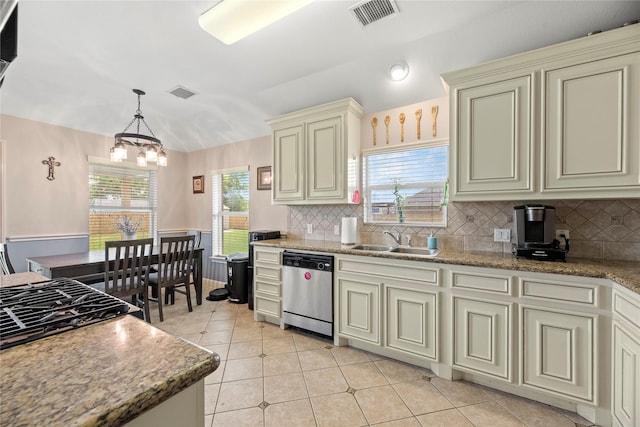 kitchen featuring cream cabinetry, backsplash, visible vents, stainless steel dishwasher, and a sink
