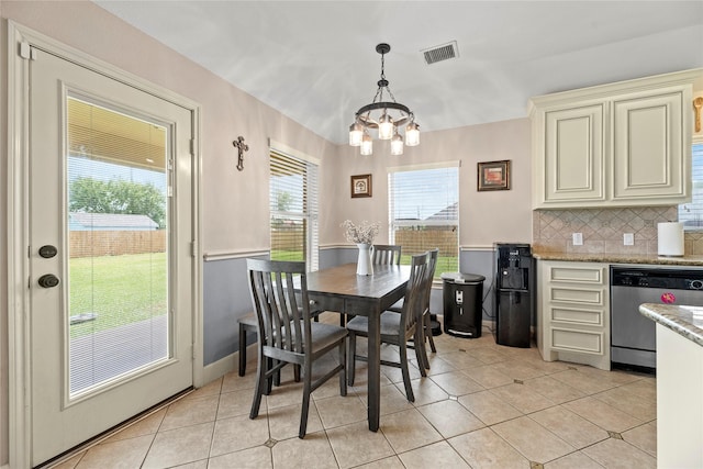 dining room featuring visible vents, a notable chandelier, and light tile patterned floors