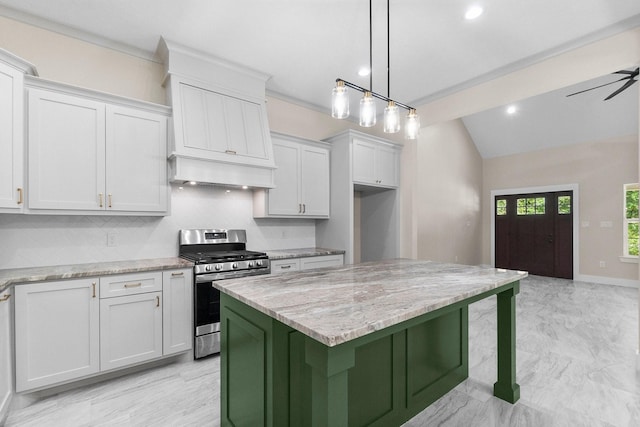 kitchen with stainless steel range with gas cooktop, backsplash, light stone counters, and premium range hood