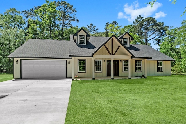 view of front of house featuring a shingled roof, an attached garage, board and batten siding, driveway, and a front yard