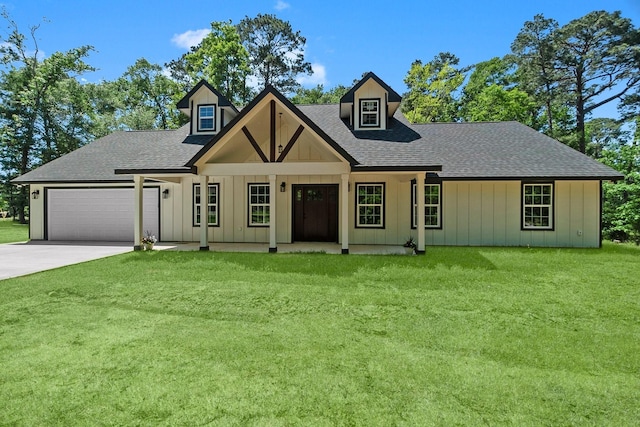 view of front facade featuring roof with shingles, a front lawn, driveway, a garage, and board and batten siding