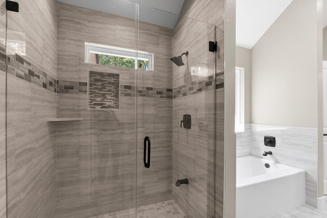 full bath with a shower stall and a garden tub