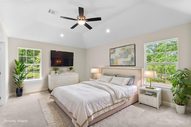 bedroom with baseboards, visible vents, light colored carpet, and multiple windows