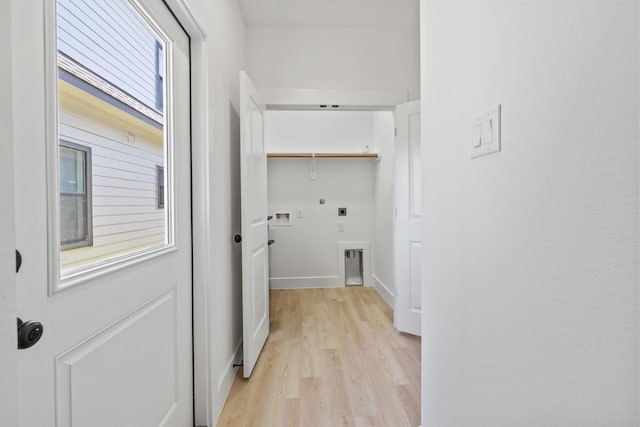 hall featuring light wood-style flooring and baseboards