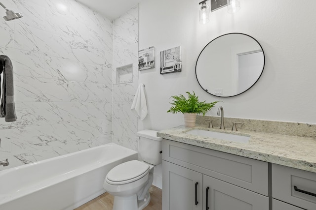 full bath featuring toilet, vanity, wood finished floors, and  shower combination