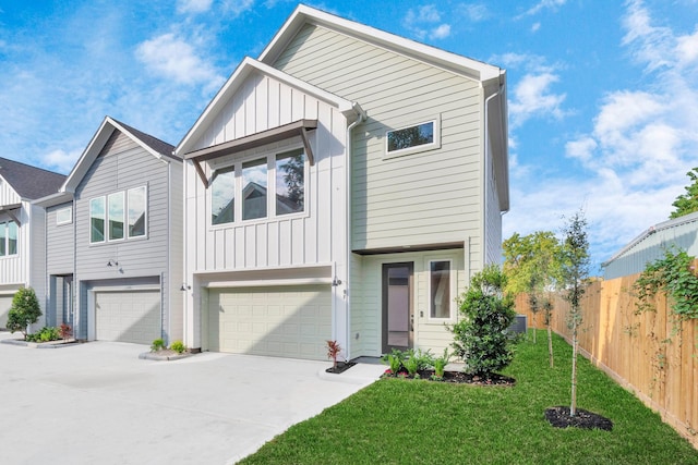 multi unit property featuring fence, a front lawn, concrete driveway, board and batten siding, and a garage