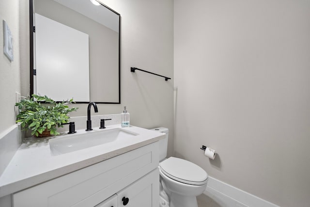 bathroom featuring toilet and vanity