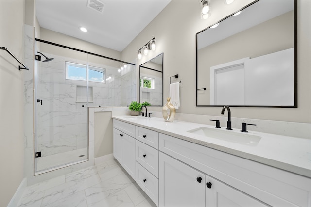 full bath featuring visible vents, a sink, marble finish floor, and a marble finish shower