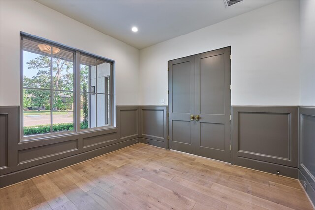 1570 Cheshire Ln, Houston, TX 77018 - spare room with a decorative wall, a wainscoted wall, light wood-style floors, and recessed lighting