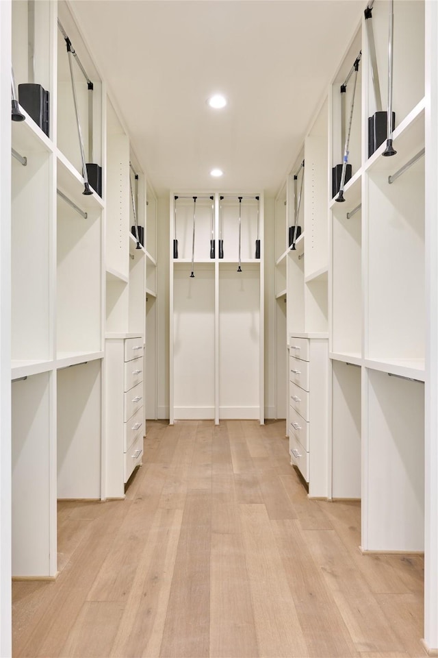 walk in closet featuring light wood-style flooring
