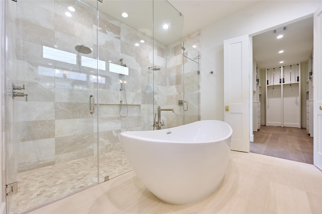 bathroom featuring a stall shower, recessed lighting, visible vents, and a soaking tub