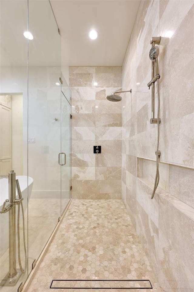 full bath featuring a freestanding tub, recessed lighting, and a stall shower