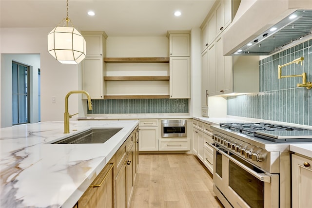 1570 Cheshire Ln, Houston, TX 77018 - kitchen with range with two ovens, premium range hood, a sink, light wood finished floors, and backsplash