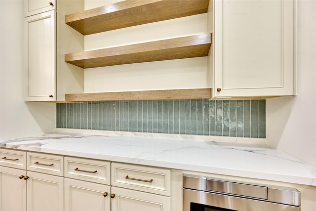 1570 Cheshire Ln, Houston, TX 77018 - kitchen featuring open shelves, wall oven, light stone counters, and white cabinets