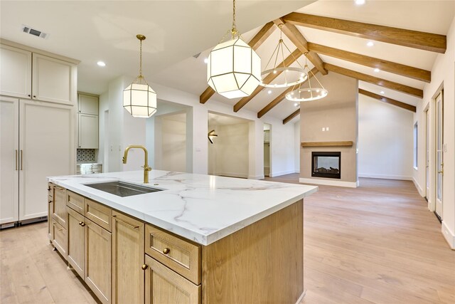 1570 Cheshire Ln, Houston, TX 77018 - kitchen with a sink, recessed lighting, a center island with sink, light wood finished floors, and decorative light fixtures