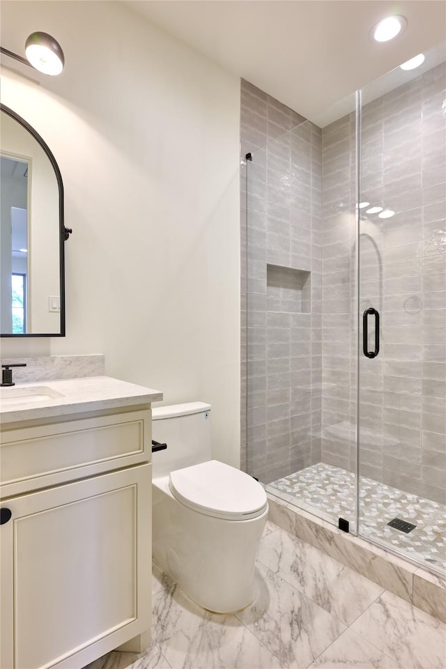 bathroom with toilet, marble finish floor, a shower stall, and vanity