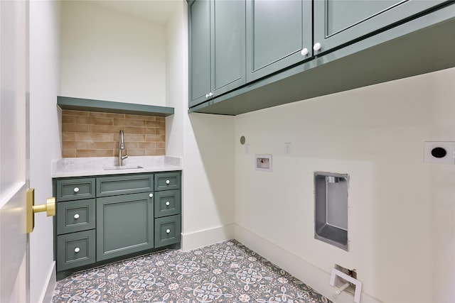 laundry area featuring hookup for a washing machine, cabinet space, hookup for an electric dryer, a sink, and baseboards