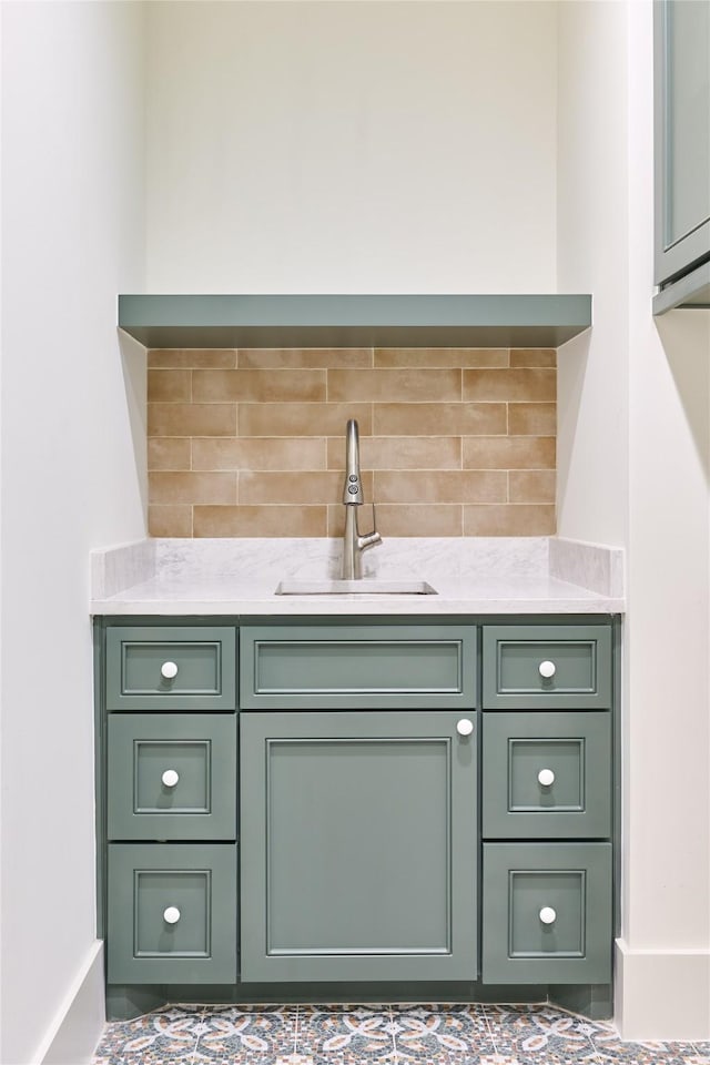 bar featuring backsplash and a sink