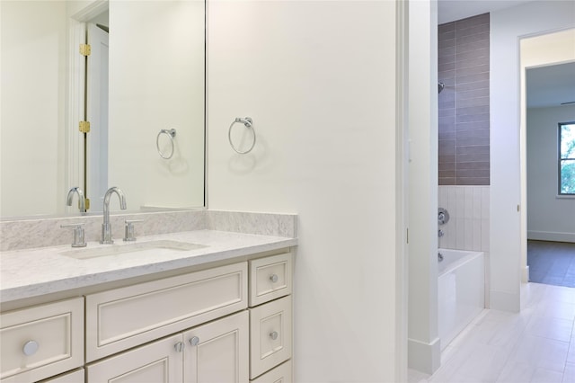 bathroom featuring baseboards and vanity