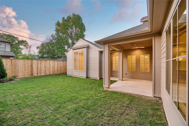 view of yard with an outdoor structure, a patio, and a fenced backyard