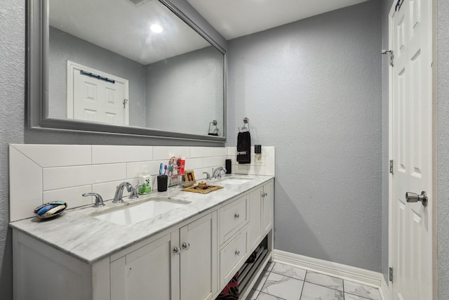 1858 Wood Orchard Dr, Missouri City, TX 77489 - full bathroom featuring baseboards, marble finish floor, decorative backsplash, and a sink