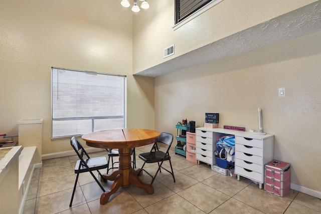 1858 Wood Orchard Dr, Missouri City, TX 77489 - dining area with a towering ceiling, light tile patterned flooring, visible vents, and baseboards