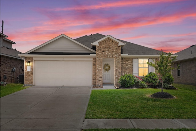 view of front of property with driveway, a garage, brick siding, a lawn, and a shingled roof