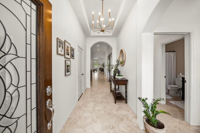 29119 Marina Point Ln, Fulshear, TX 77441 - entrance foyer with arched walkways, a chandelier, and baseboards