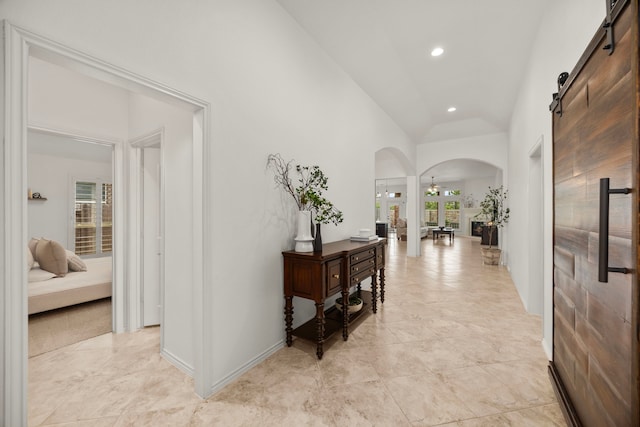 29119 Marina Point Ln, Fulshear, TX 77441 - hall featuring arched walkways, lofted ceiling, recessed lighting, and a barn door