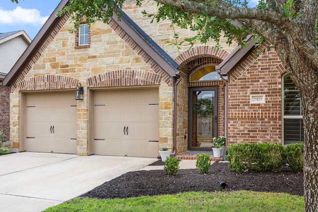29119 Marina Point Ln, Fulshear, TX 77441 - view of front of home with an attached garage, driveway, brick siding, and stone siding